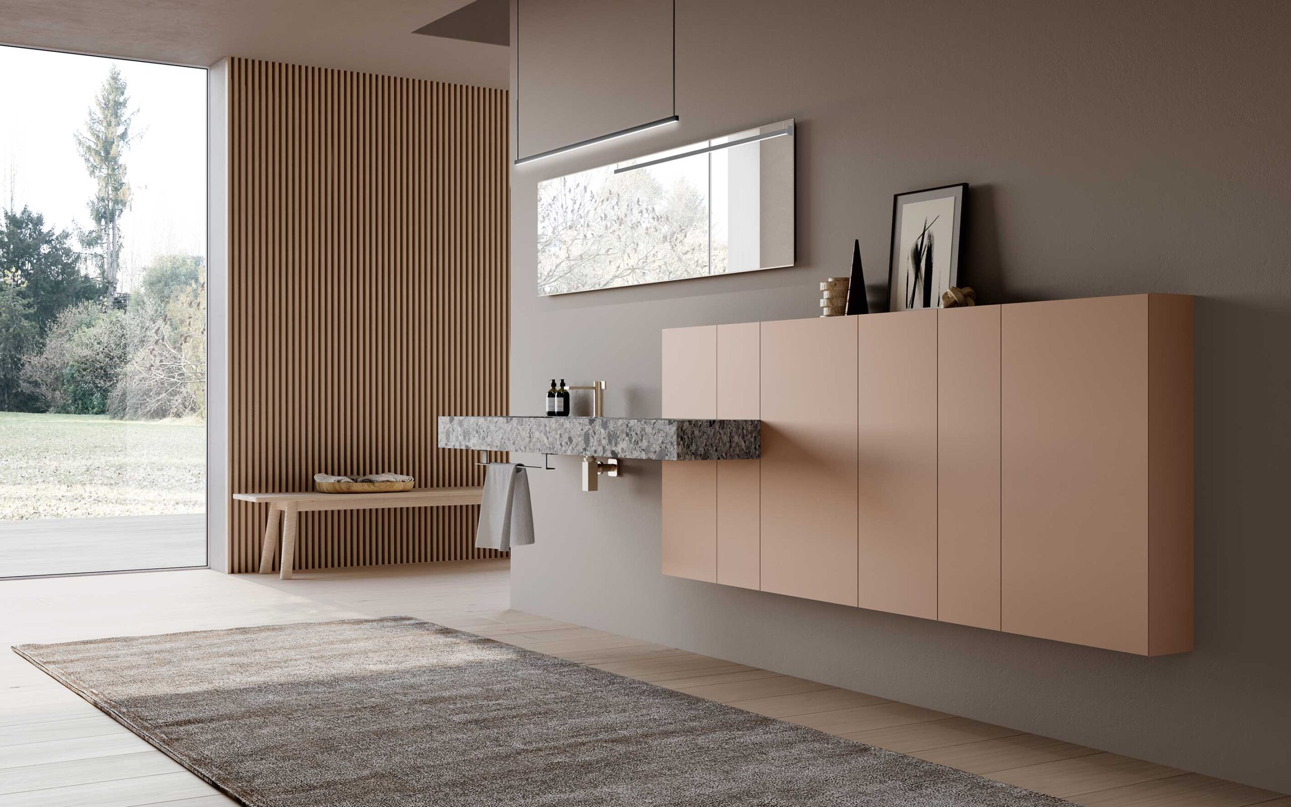 Mobile bagno moderno con cassetti chiari, lavabo grigio e ampia finestra sul verde.