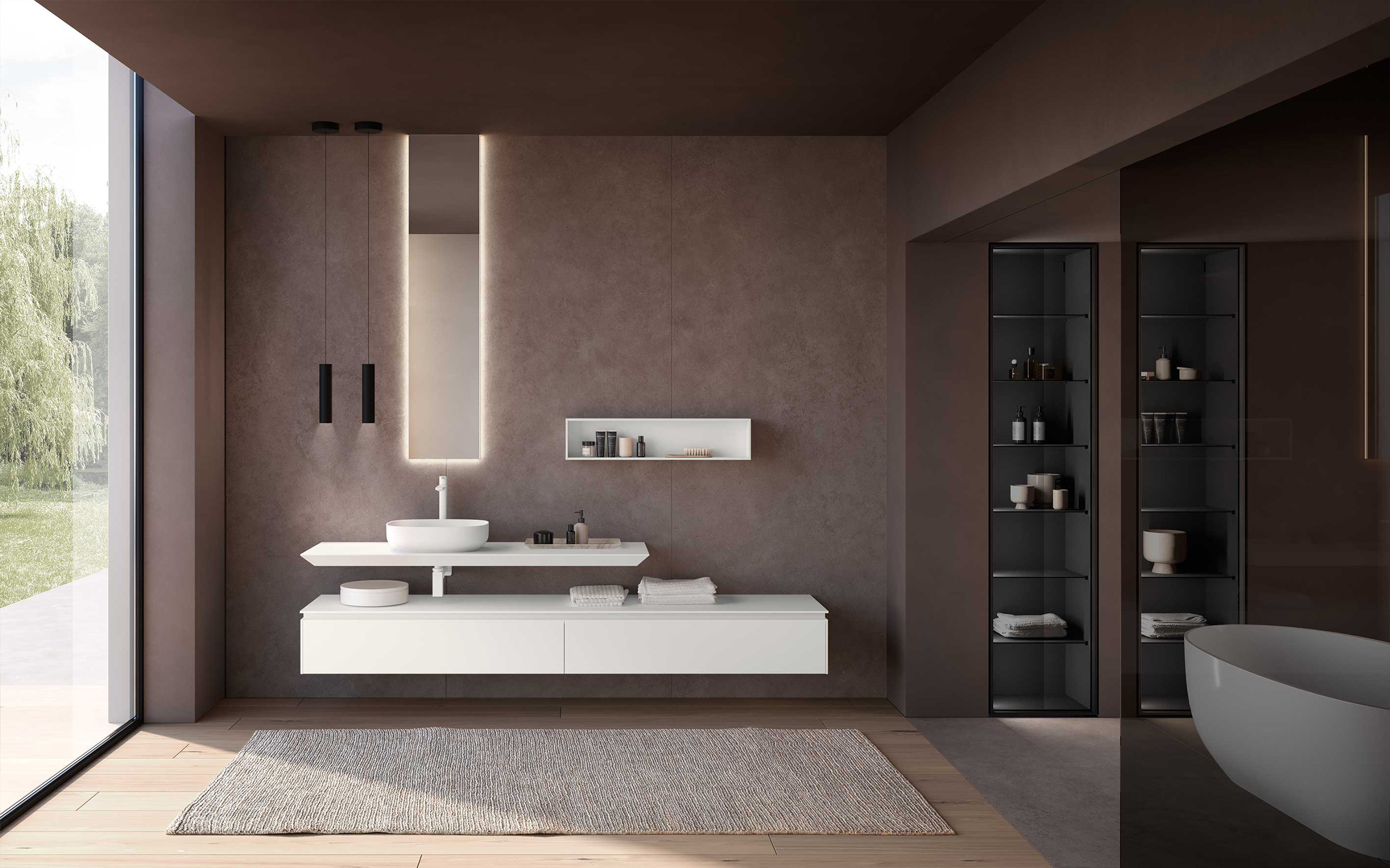 Bagno moderno Azzurra Lime 2.0 con mobile sospeso bianco, lavabo d'appoggio, specchio retroilluminato verticale, nicchia portaoggetti, vetrine illuminate e vasca freestanding in un ambiente dal design essenziale.