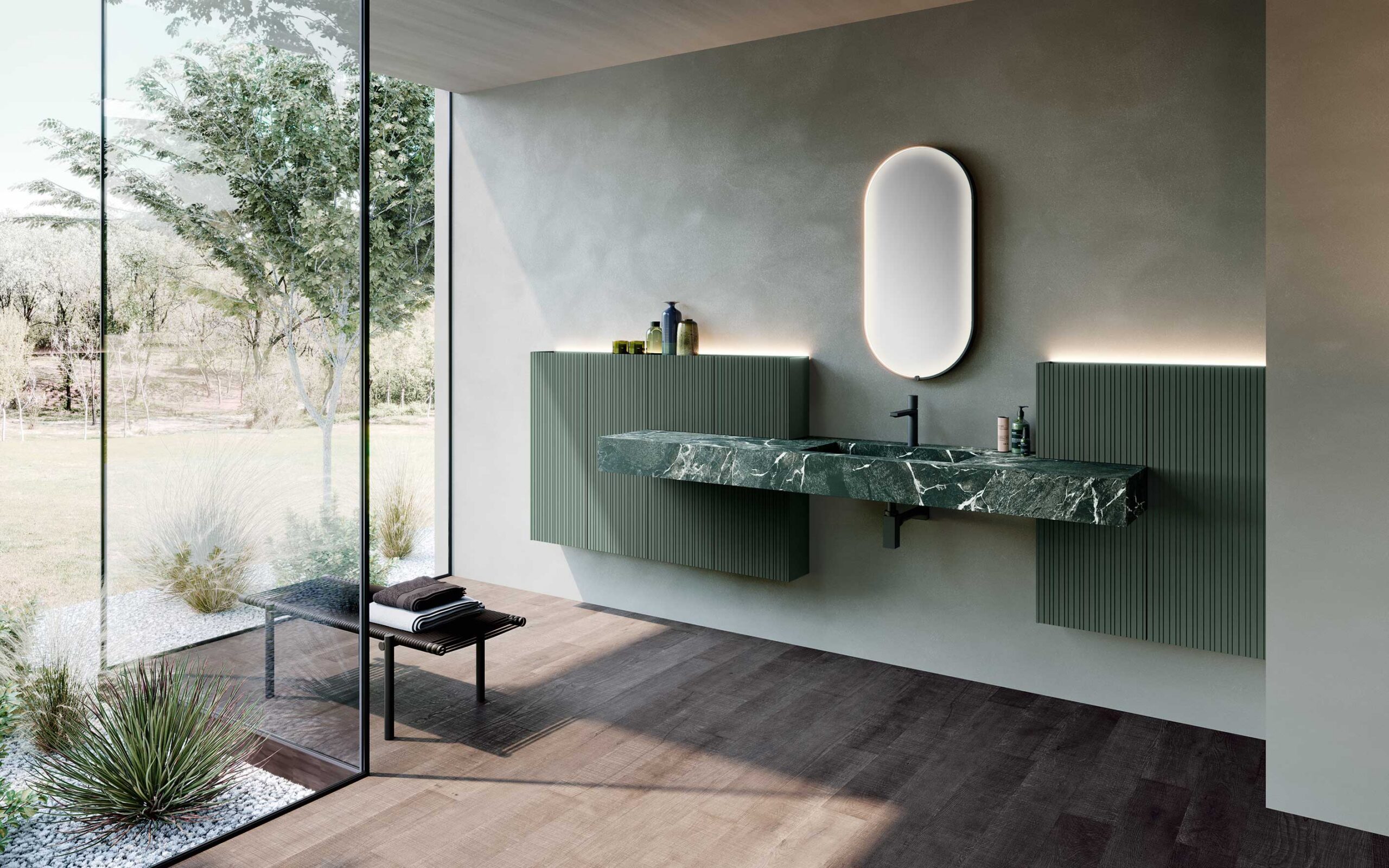Lavabo integrato verde con rubinetteria nera, inserito in una composizione bagno moderna con mobili sospesi coordinati.